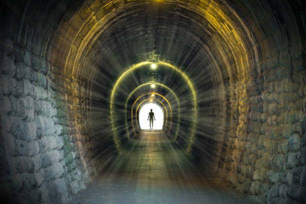 istock Light at the end of ancient narrow tunnel 831187338