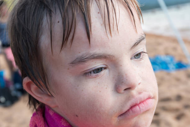 istock Boy With Downs Syndrome at the Beach 831187848