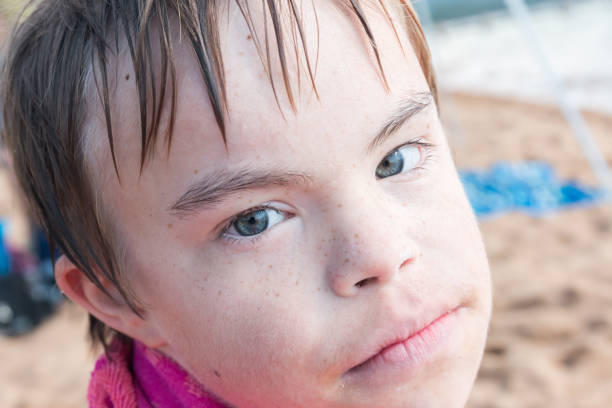istock Boy With Downs Syndrome at the Beach 831187860