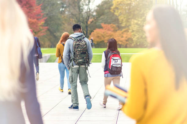 istock University students walking in the park 831194198