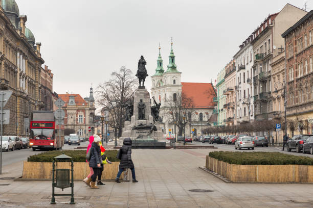 People walk in front of monument on Jan Matejko square commemorating the Battle of Grunwald, 15 July 1410. Krakow is one of the oldest cities in Poland.