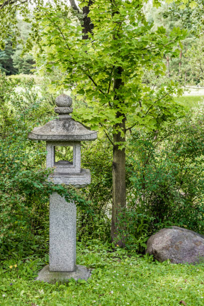 istock Stone lantern on the shore of the pond 831202702