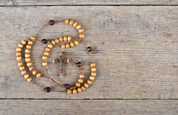 istock Rosary beads on the old wooden table 831206662