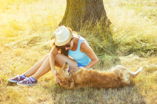 istock Young woman having a fun with her dog 831209960