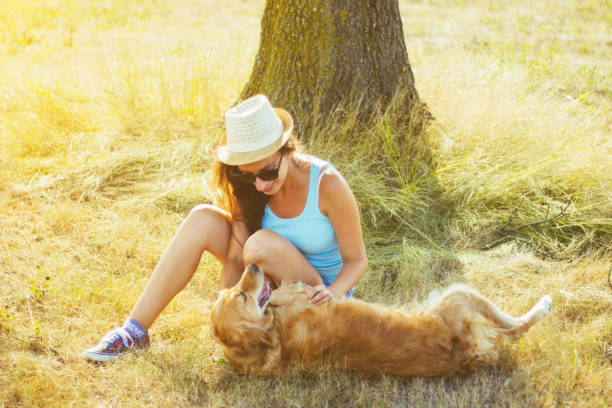 istock Young woman having a fun with her dog 831210096