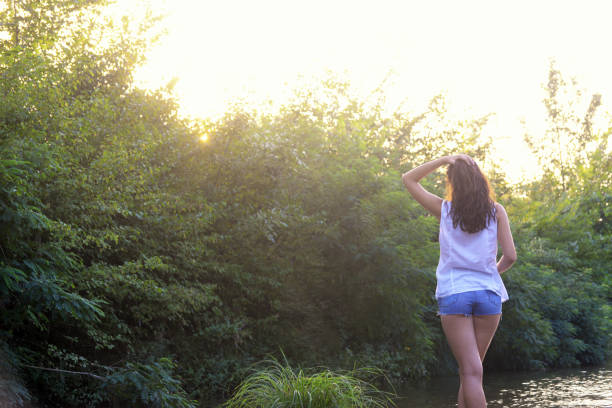istock Handsome girl poses by the river 831216788
