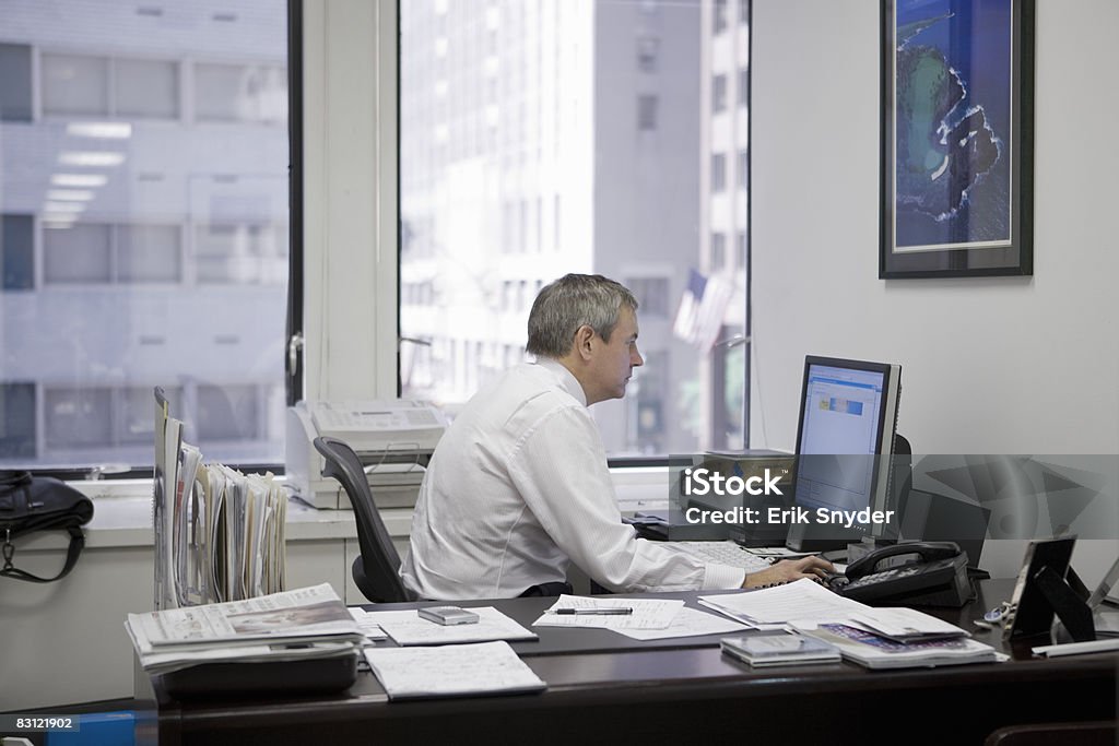 man in office using computer  Desk Stock Photo