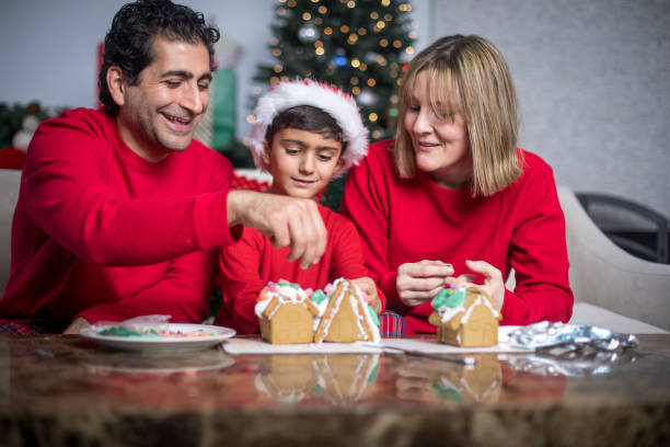 istock Family Making Gingerbread House 831219070