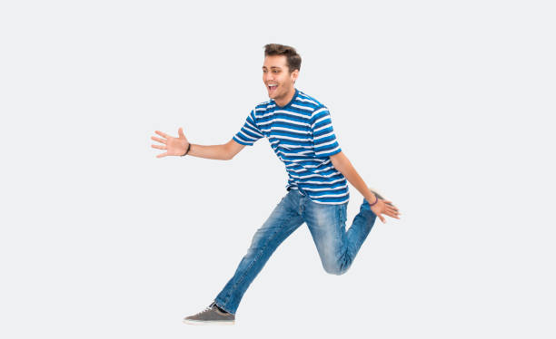 istock Portrait of laughing young man jumping on white background 831222814