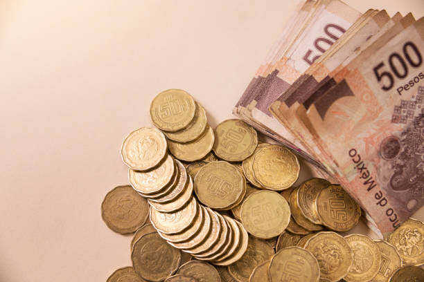 istock mexican coins and banknotes background 831226858