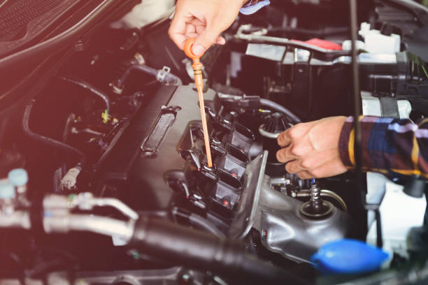 istock Close up hands checking lube oil level of car engine from deep-stick for service and maintenance concept. 831242088