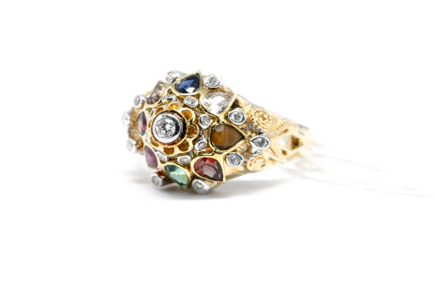 istock Emerald, Blue Sapphire and Pink Diamond with white diamond and gold ring isolated 831249394
