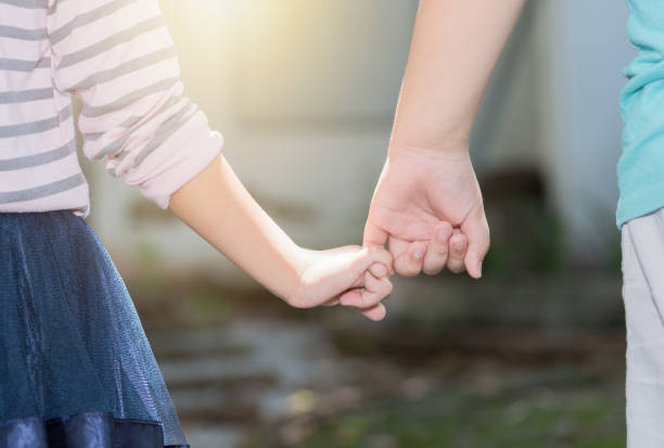 istock Brother and sisters holding hand in hand 831249636