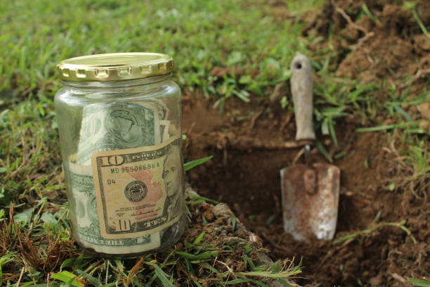 istock Jar of Money Buried 831256942