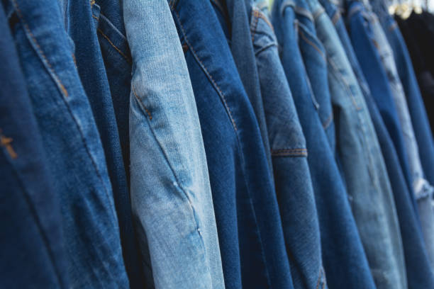 istock Blue denim jeans background. Blue jeans lined  in market. 831260756
