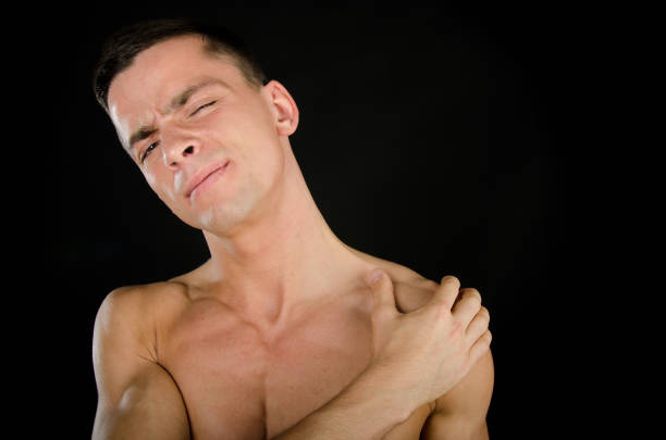 istock Pain in the shoulder. Attractive guy. Black background. 831264638