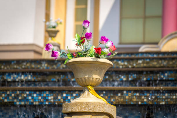high angle view of a decorative fountain in a mossy and unkempt fish pond
