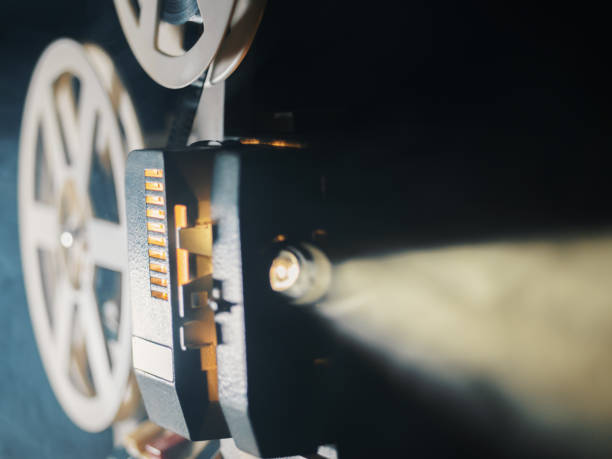 istock film projector on a black background with dramatic lighting and selective focus 831269710