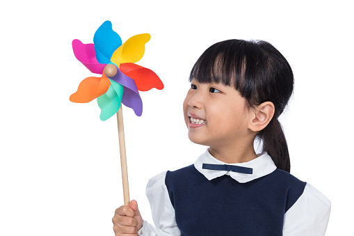 Asian Little Chinese Girl Playing Colorful Pinwheel in isolated White Background