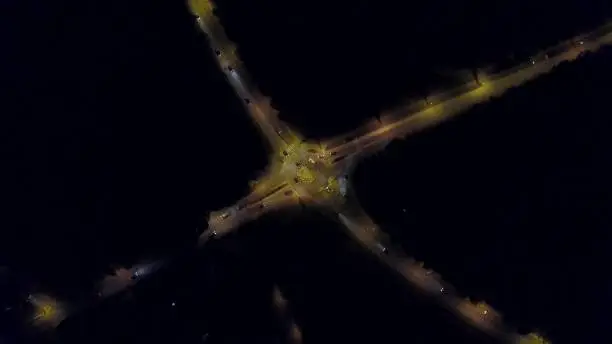 Aerial top down view of a car road roundabout at night