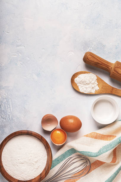 istock Ingredients for baking  - flour, wooden spoon, rolling pin, eggs. 831293934