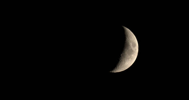 istock Waxing crescent moon seen with telescope 831295294