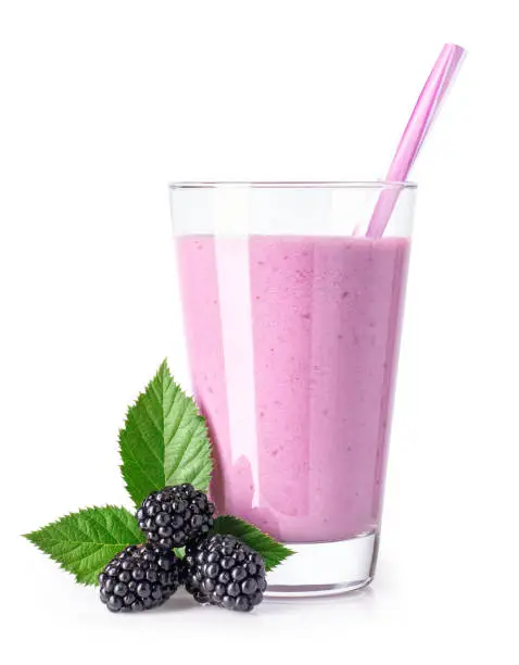 blackberry milkshake with straw in glass and fresh ripe berries near isolated on white background. Healthy drink