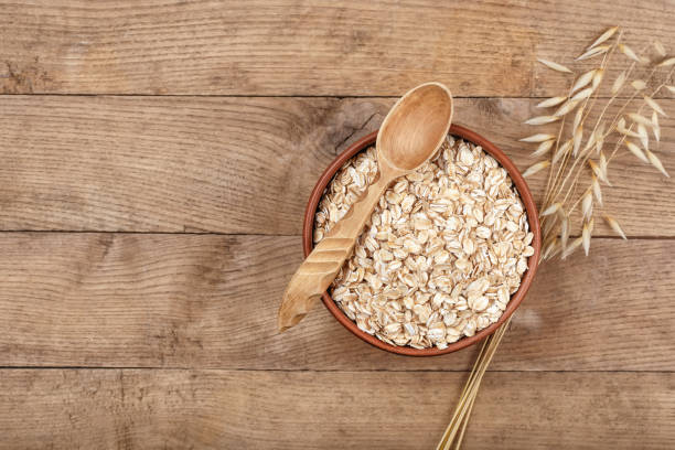 istock Uncooked oatmeal in bowl and oat ear 831296108