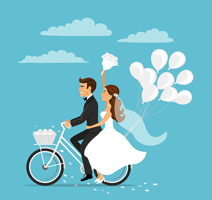 Just married happy couple bride and groom riding bicycle with balloons