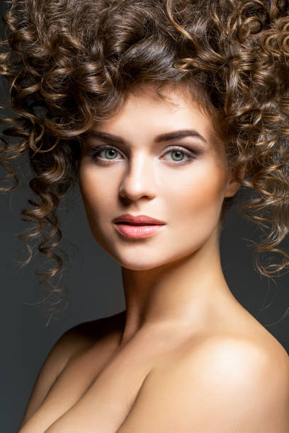 istock beautiful girl with curly hairdo 831307628