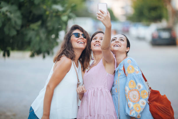 istock Three beautiful women taking selfie by smartphone 831312052