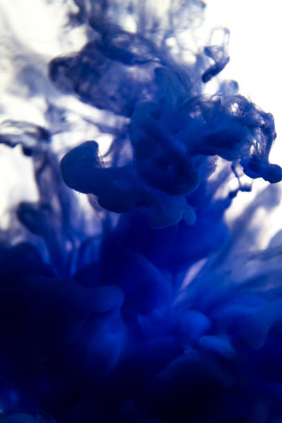 istock blue ink in water isolated on white background 831314226