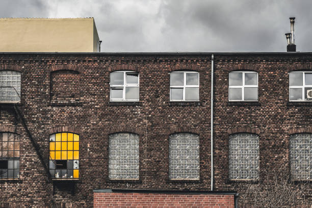 istock Old abandoned building with single yellow window 831319428
