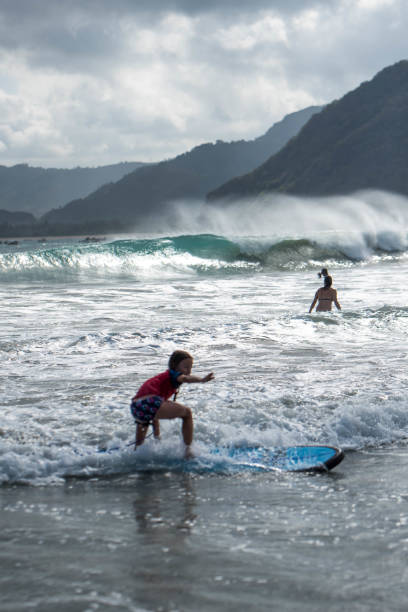 istock Little surfing girl 831319638