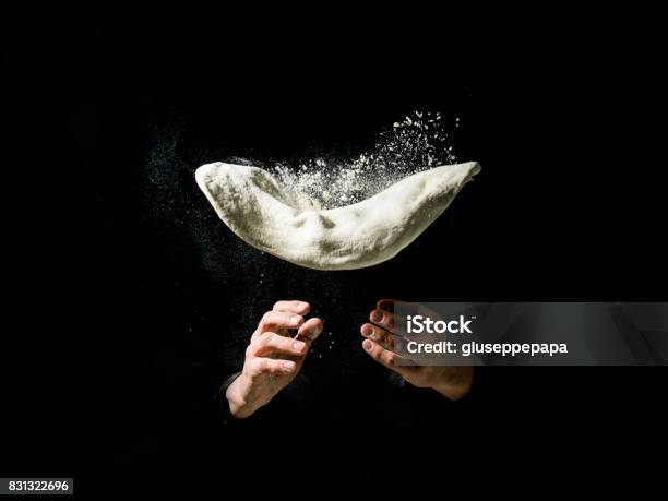 Pizza Cook To Work With Flying Pizza Dough Stock Photo - Download Image Now - Pizza, Dough, Making