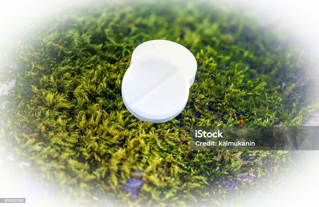 White pills on a green background Addiction Stock Photo