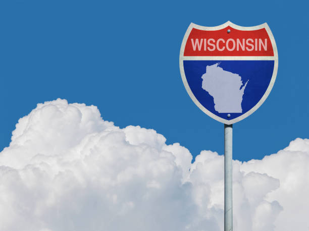 istock Highway sign for Interstate road in Wisconsin with map in front of clouds 831326280