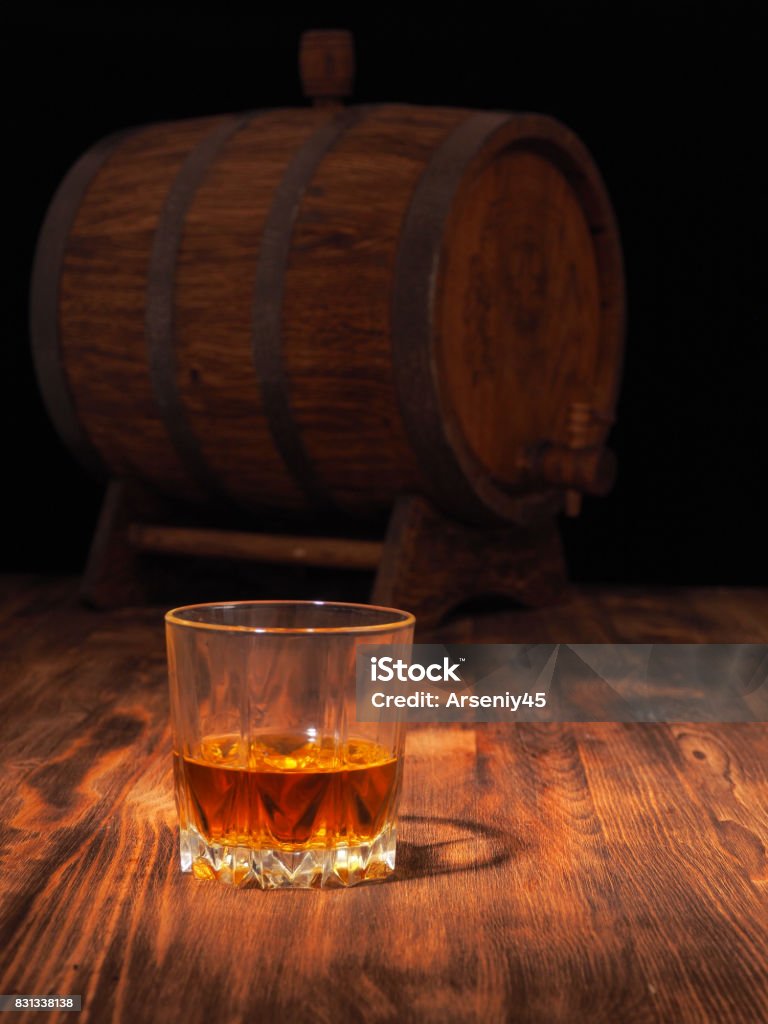 Glass of whiskey and vintage wooden barrel Glass of whiskey and vintage wooden barrel. Barrel Stock Photo