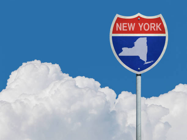 istock Highway sign for Interstate road in New York with map in front of clouds 831341574
