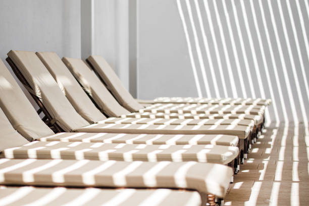 istock Comfortable rattan chaise longues with soft mats 831342310