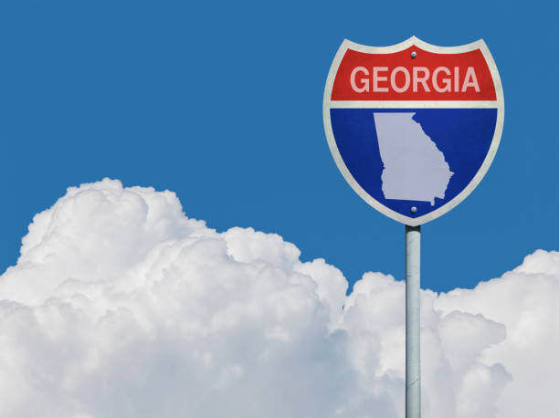istock Highway sign for Interstate road in Georgia with map in front of clouds 831345272