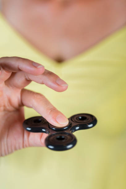 istock woman with a fidget spinner 831345790