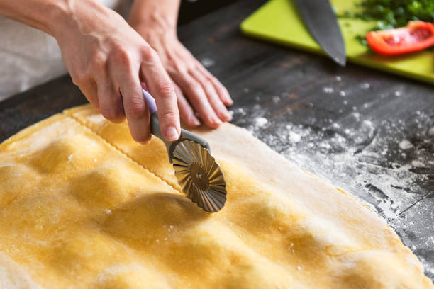 istock Woman chef cooks step by step the traditional ravioli 831348270
