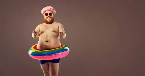 Photo of Fat funny man in an inflatable ring.
