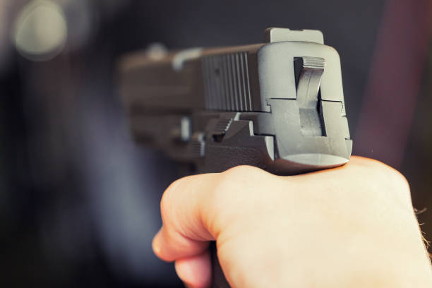 istock Man holding gun in hand and ready to use it 831348386