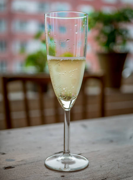 istock Champagne glass on wood table at home. 831349344
