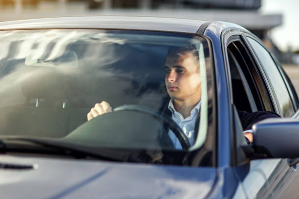 Selective focus of elderly man hands on steering wheel driving a car on the speed highway. View from above