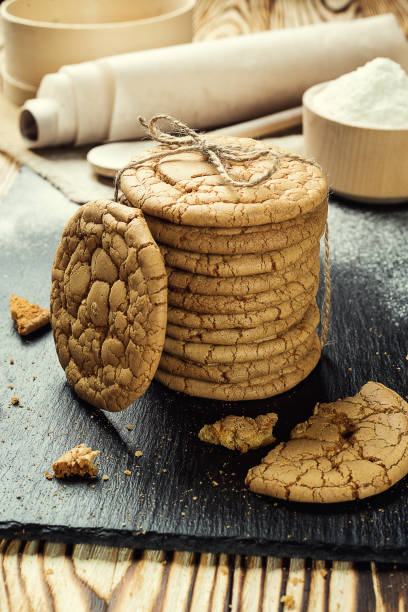 istock Biscuit sweet cookie background. Domestic stacked butter biscuit pattern concept,close up macro.Homemade cookies on wooden table.Cereal biscuits with the sesame,peanuts,sunflower and amaranth. 831356252