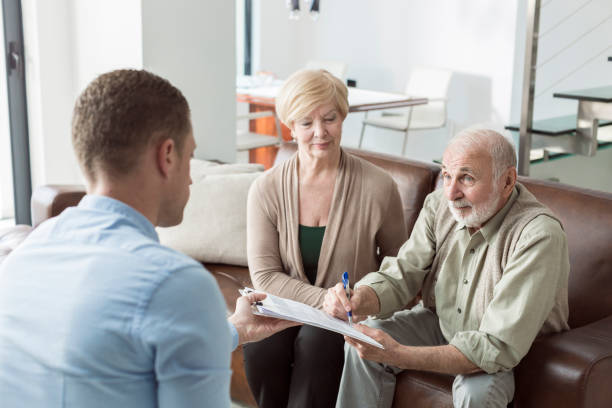 istock Senior couple signing financial papers 831356376
