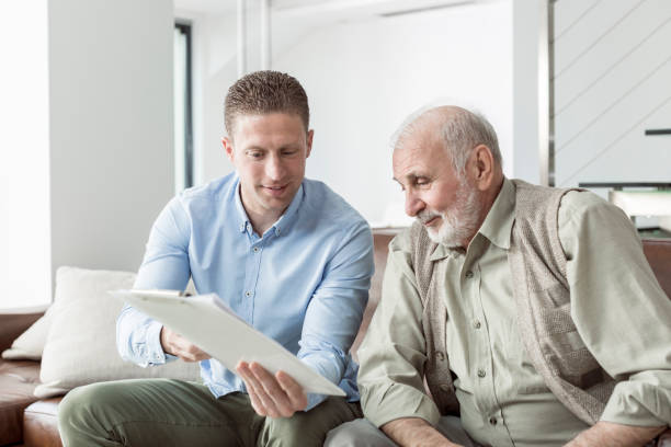 istock Senior man discussing his finances with their advisor 831357042